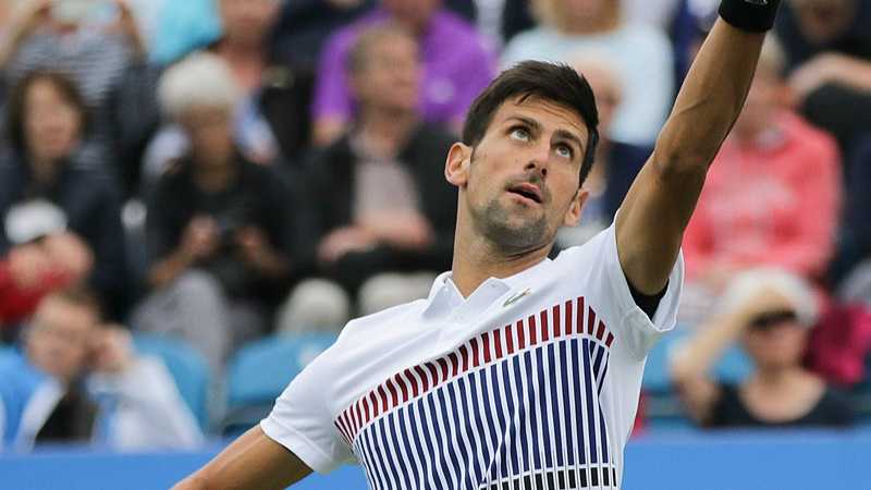 Djokovic serving at the Eastbourne International. Djokovic plays with a Head racquet and wears Lacoste apparel and Asics shoes., tags: novak en bøde french - CC BY-SA