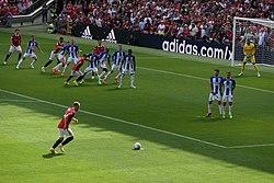 Eriksen taking a free kick for Manchester United on the opening day of the 2022–23 Premier League season, tags: ali mccann em - CC BY-SA