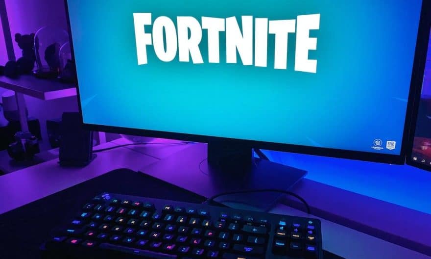 black flat screen computer monitor with black computer keyboard - Fortnite game loading on a gaming setup., tags: onlinespil - unsplash