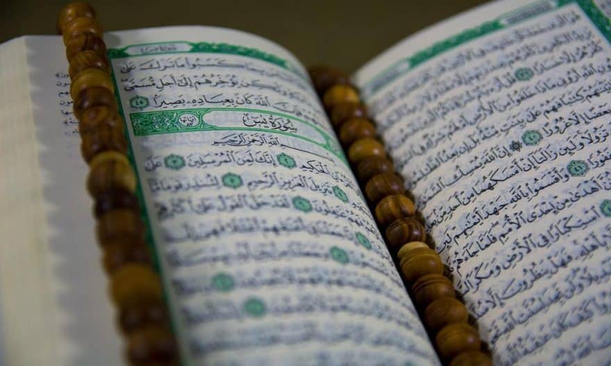 text - Closuep of Muslims Holy Book Quran Majid Closeup of Islamic Book Quran in Arabic Text and a Tasbeeh on it, tags: danmark som svar på - unsplash