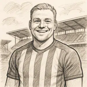 Victor Froholdt, dansk fodboldspiller, smilende i klubtrøje foran stadiontribunen.