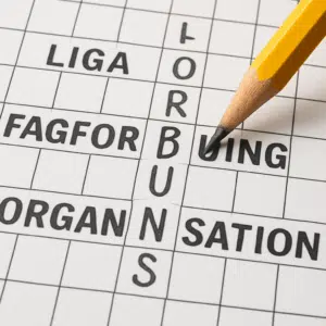 Blyant skriver “forbund” i en krydsordsrude, omgivet af forslag til synonymer og løsningsord.